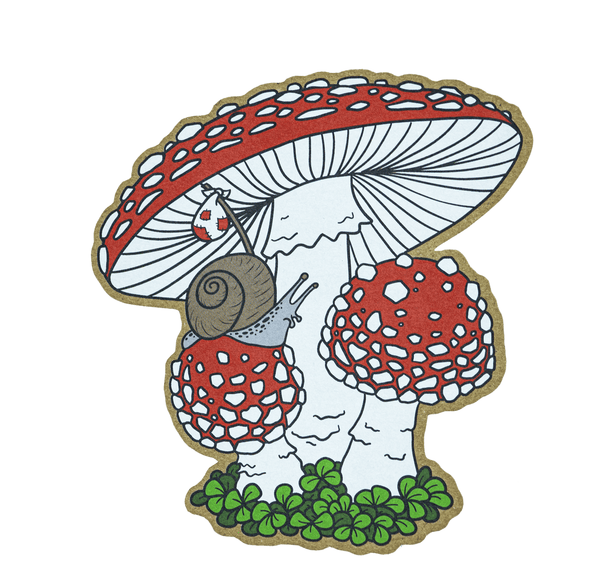 A brown kraft sticker of a grey snail carrying a bindle as he explores red and white Fly Agaric (Amanita muscaria) mushrooms, with green moss below.