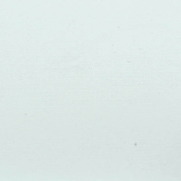 A closeup video of a man stamping on white paper, leaving the impression of three bats flying across a circle silhouette.