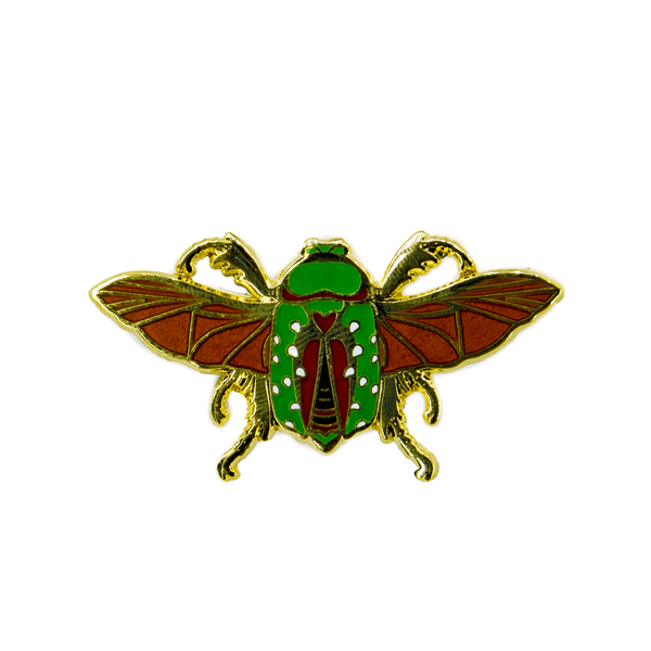 A red, green, white, orange, and gold enamel pin of the Mistletoe Beetle (Stephanorrhina guttata) with wings outstretched.