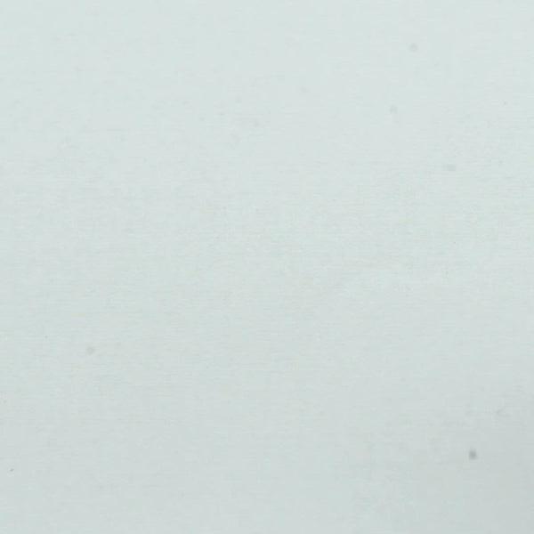 A closeup video of a man stamping on white paper, leaving the line art of a small stylized skull.