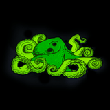 A large octopus enamel pin glowing bright green in the dark.