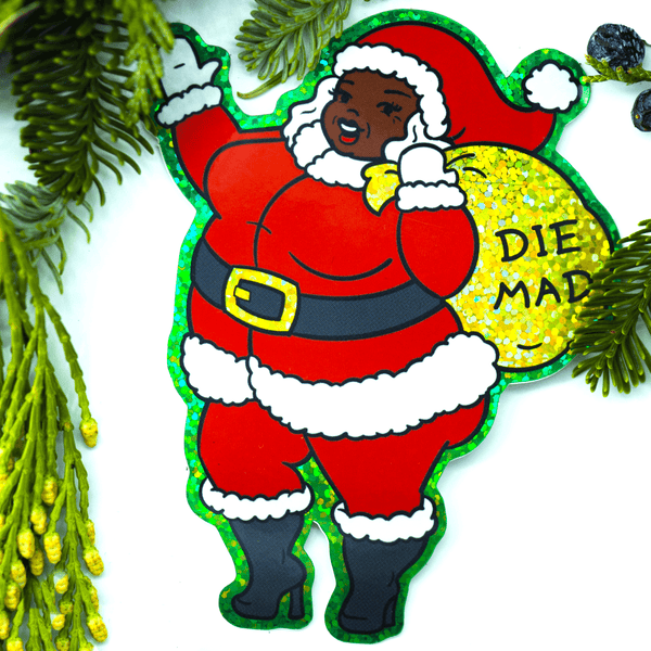 A vinyl sticker of a black woman Santa, dressed in red and white with black high heel boots, waving with a smile. Her bag reads "DIE MAD" and glitters. The sticker border glitters green.